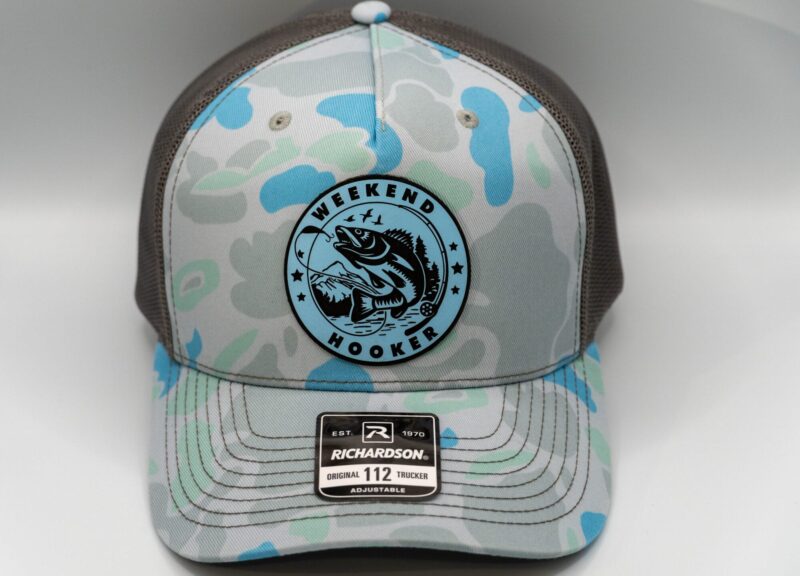 Camo trucker hat with a laser engraved Weekend Fishing leather patch